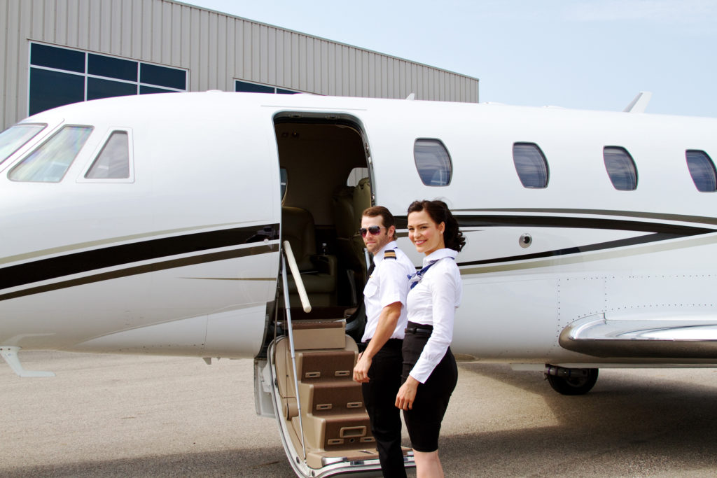 Pilot and stewardess turn as they enter jet